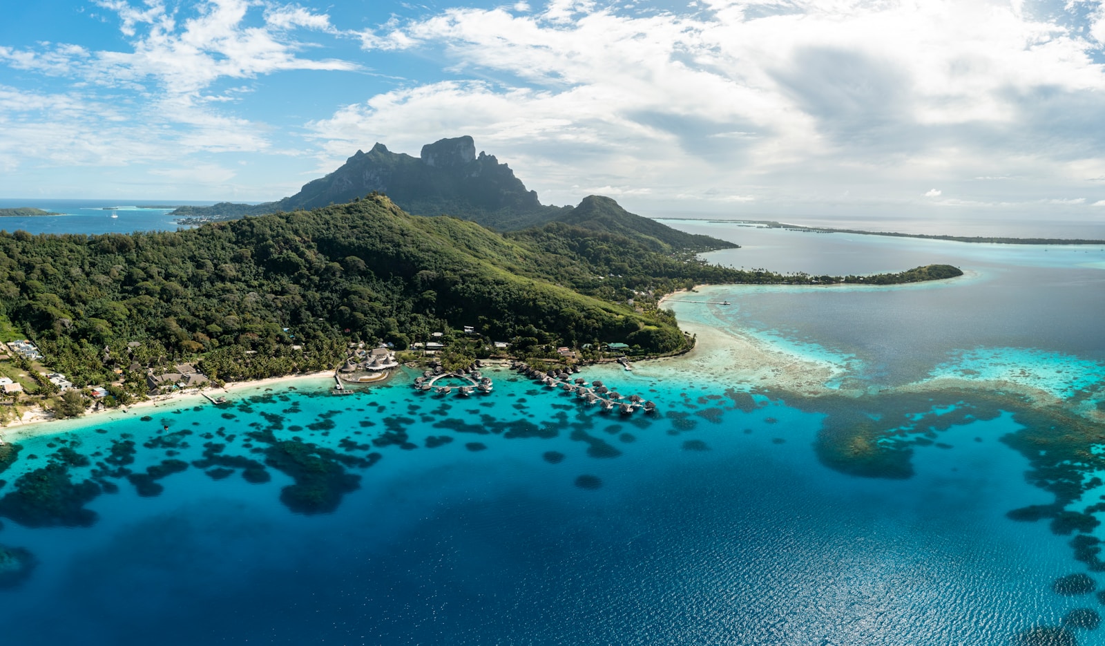 an aerial view of a tropical island in the middle of the ocean